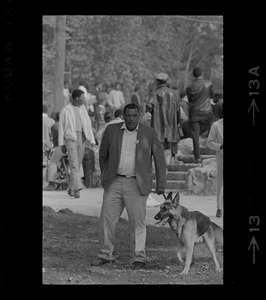 Unidentified Black man and a dog seen at the Black student rally in Franklin Park