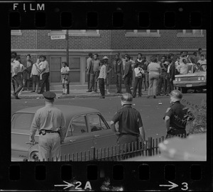 Crowd of people gathered in front of building on Washington Street, near Jeremiah E. Burke High School in Dorchester, during student demonstrations