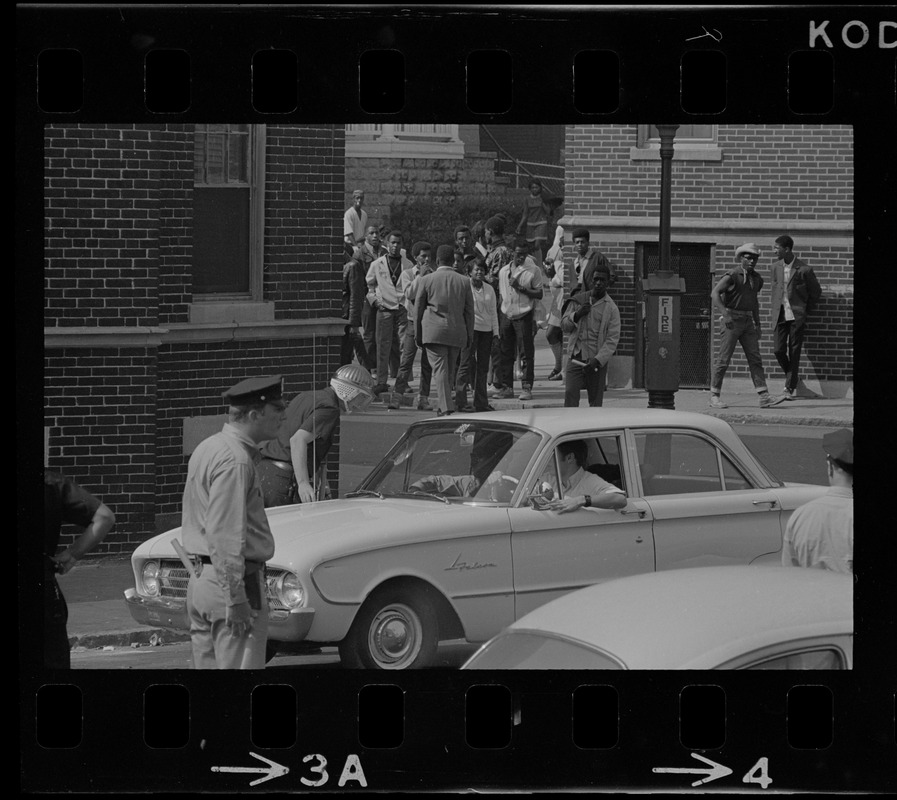 Police and crowd on Washington Street near Jeremiah E. Burke High School during time of student demonstrations