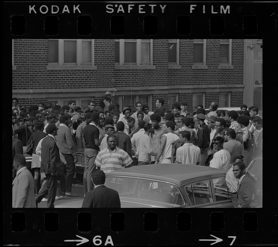 Crowd in middle of Washington Street near Jeremiah E. Burke High School during time of student demonstrations