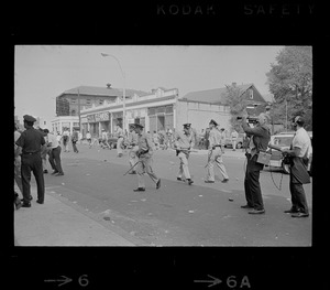 As violence erupted after rally...the action then shifted to Washington Street in front of the Jeremiah E. Burke High School where Boston Police cadets had to duck from rocks (shown littering street) being hurled at them by the demonstrators
