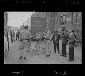 Police on Washington Street near Jeremiah E. Burke High School putting on riot gear after unrest broke out during student demonstrations