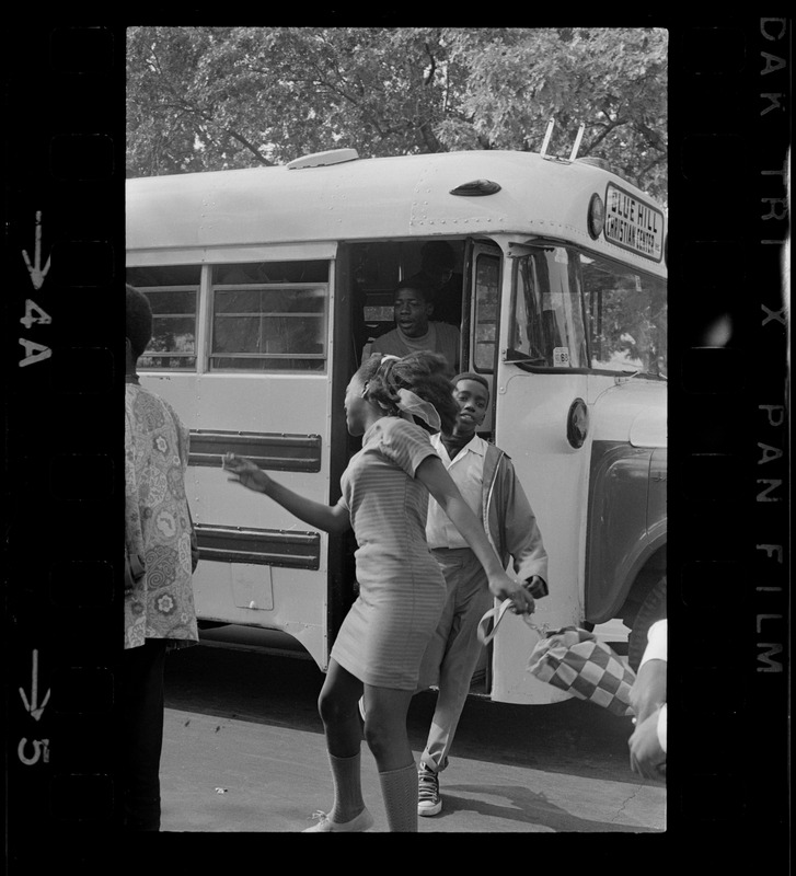 Students exiting a Blue Hill Christian Center bus, possibly for the Black student rally in Franklin Park