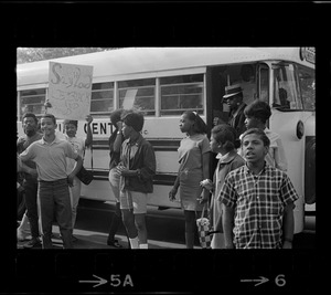 Students standing near a Blue Hill Christian Center bus, possibly for the Black student rally in Franklin Park