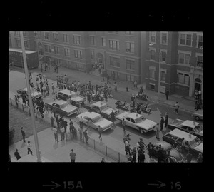 Birdseye view of police cars and crowds, most likely in front of Jeremiah E. Burke High School after unrest broke out during student demonstrations