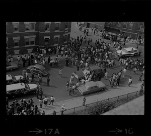 Birdseye view of crowd spilled into street, most likely students in front of Jeremiah E. Burke High School during student demonstrations