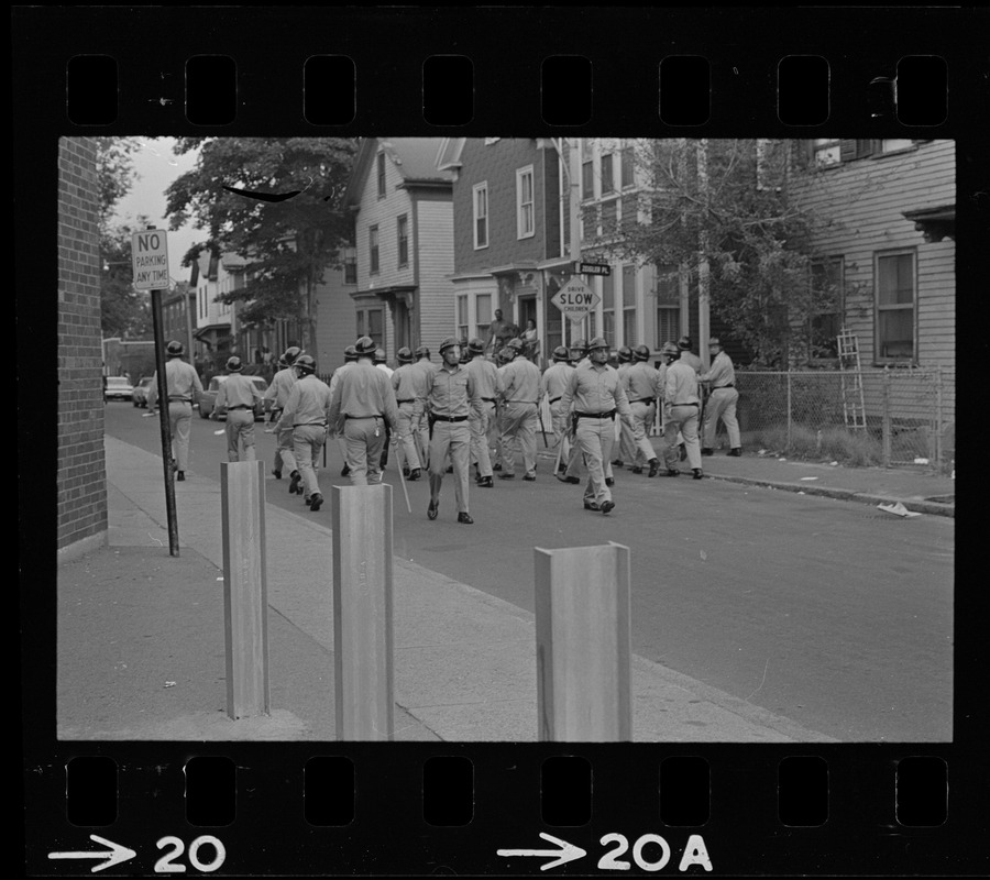 Riot police in the middle of a street near Zeigler Place in Roxbury after unrest broke out during student demonstrations