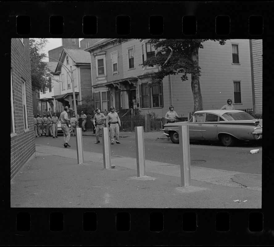 Riot police in the middle of a street near Zeigler Place in Roxbury after unrest broke out during student demonstrations