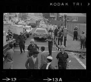 Police, patrol cars and people on the corner of Zeigler St. and Harrison Ave. during the time of student demonstrations at nearby high schools