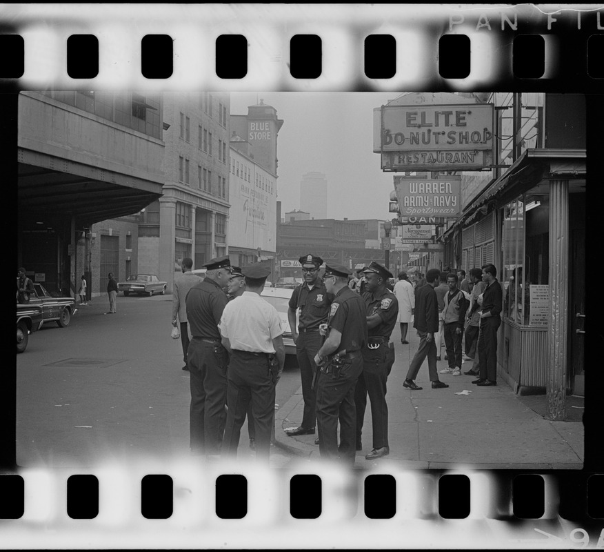 Police in front of Elite Donut Shop, across from the Dudley St. MBTA terminal, most likely during student demonstrations