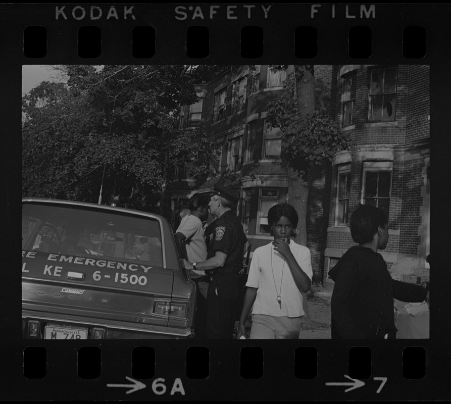 Police and a few people standing beside a Fire Emergency vehicle most likely during the time of student demonstrations