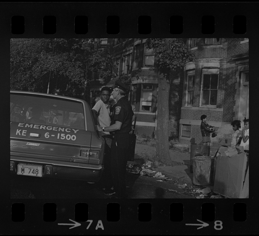 Police and a few people standing beside a Fire Emergency vehicle most likely during the time of student demonstrations