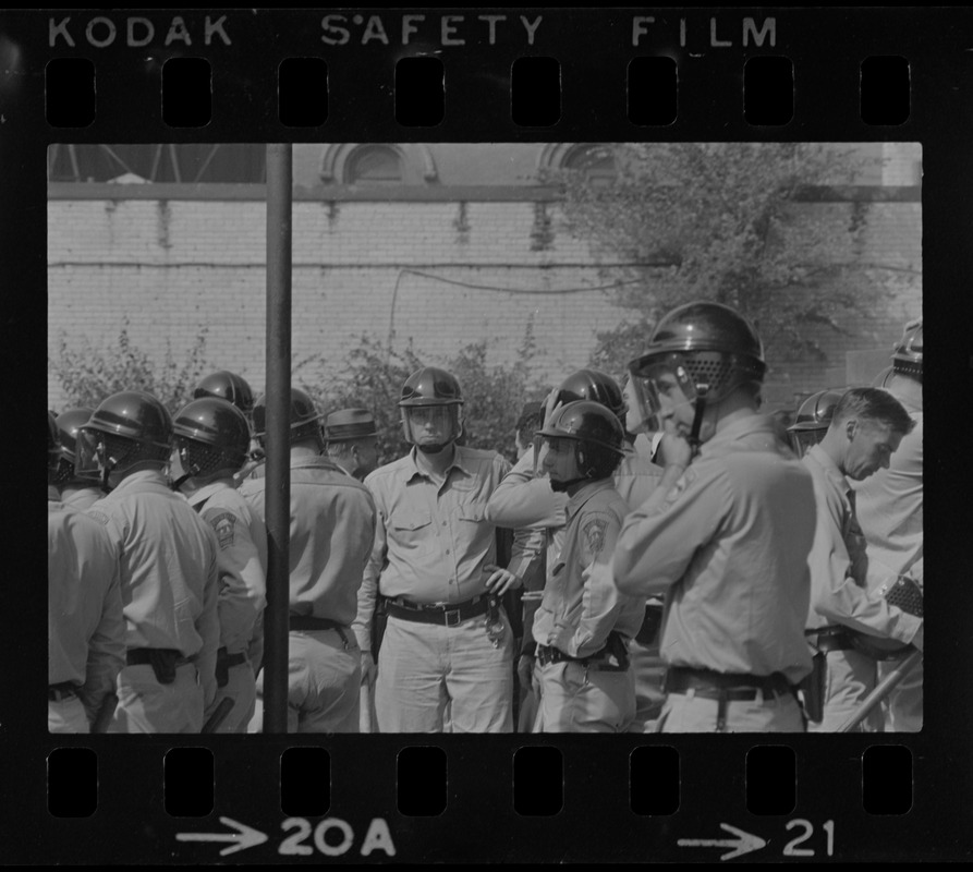 Riot police gathered together, most likely near Jeremiah E. Burke High School after unrest broke out during student demonstrations