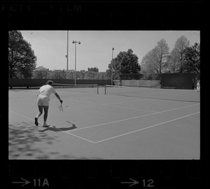 State Treasurer Robert Q. Crane playing tennis against Mayor Kevin White, most likely at the Boston Common tennis courts