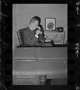 Boston young mayor Kevin White taking a call from his desk at his office in City Hall