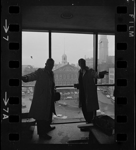 Mayor-elect Kevin H. White and Robert Morgan, Government Center Commission chairman, are silhouetted against famed Faneuil Hall Market as White visited the new City Hall for the first time Friday