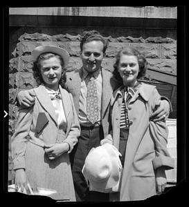 A man and two women pose