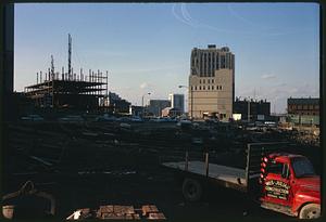 Construction area with cars and buildings in background, Boston