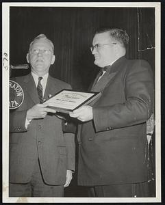 Best Sports Picture Award of 1955 is presented Herald Staff Photographer Russ Adams (right) by Mayor Hynes at Boston Press Photographers' annual ball. Adams' sequence strip showed mayor, with olive wreath, running after Japan's Hideo Hamamura, who won BAA Marathon.