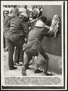 Search Demonstrator-- Police search a Negro counter-picket after gunfire broke out near the U.S. Customs House today in Chicago where hundreds of white constructions workers massed to block the main entrance. Inside, Labor Department officials were conducting a hearing into charges of racial discrimination in the hiring of workers on government-financed projects.