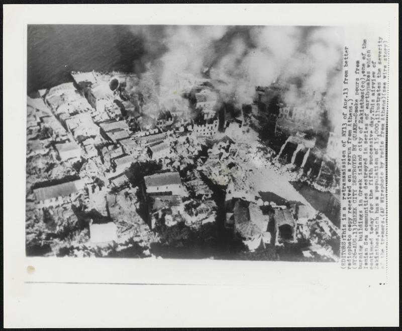 Greek City Destroyed by Quake--Smoke pours from burning buildings in Greek island city of Zakinthos (cq), one of the Ionian Sea communities destroyed in series of earthquakes which continued today for the fifth successive day. This airview of Zakinthos, which has a population of 15,000, illustrates the severity of the tremors.