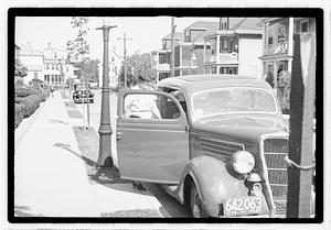 A woman entering a car
