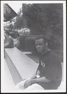 Young man sitting with a camera