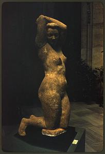 Sculpture of kneeling nude woman