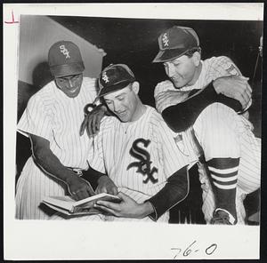 Latin Members of the White Sox brush up on their English with the help of a dictionary. Left to right, Third Baseman Orestes Minoso, Shortstop Chico Carrasquel and Pitcher Luis Aloma. The trio do all right in their native Spanish, but find a bit of difficulty with English.
