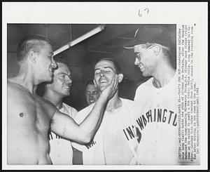 St. Paul - Minneapolis - That's Our Boy - Washington infielder Dale Long (left) holds the chin of pitcher Joe McClain, after the Senators defeated the home-opening Minnesota Twins, 5-3. Pitcher Dave Sisler (right) came on in relief to  quell a 9th inning Twins rally. Long Homered in the first. Catcher Pete Daley (second from left), shares in the dressing room fun after driving in two runs in the game.