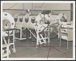 Lifesaving Respirators are shown at work in City Hospital as two patients lie side by side, battling polio. Boston's outbreak this year is of serious proportions, calls for extra nurses and technicians now being recruited by hospitals.