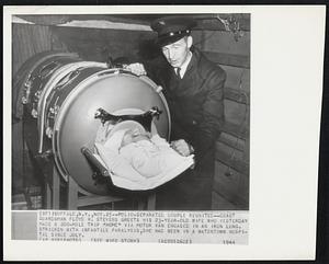 Polio-Separated Couple Reunited -- Coast Guardsman Floyd H. Stevens greets his 23-year-old wife who yesterday made a 200-mile trip "home" via motor van encased in an iron lung. Stricken with infantile paralysis, she had been in a Watertown Hospital since July.