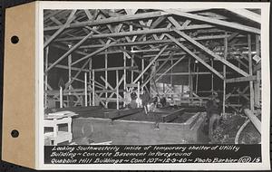 Contract No. 107, Quabbin Hill Recreation Buildings and Road, Ware, looking southwesterly inside of temporary shelter of utility building, concrete basement in foreground, Ware, Mass., Dec. 9, 1940