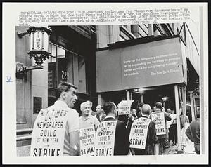 Sign overhead apologizes for "temporary inconvenience" as pickets march outside the New York Times building 9/16 after the American Newspaper Guild went on strike against the newspaper. Six other major dailies later suspended publication in sympathy with the Times as part of a publishers' agreement to stand united against the union.