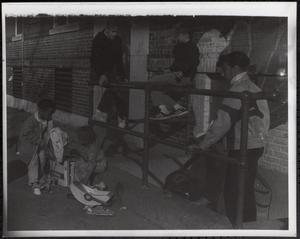 Brian Gomes, Jimmy Driscoll and other children outside near a stairwell