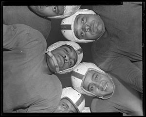 Football players in a huddle shot from below