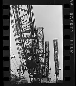 Folded construction cranes in storage yard, Everett