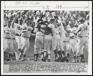 Dodgers Go Wild--Manager Walter Alston (extreme left) joins the charge as the Los Angeles Dodgers mob pitcher Sandy Koufax seconds after winning the World Series from the Yankees yesterday. Koufax is surrounded by group at center. Also at left are coach Pete Reiser (second from left) and bat boy. At extreme right is Bill Skowron (14), ex-Yankee who was a Dodgers’ series hero. Los Angeles won 2-1 to sweep the series.