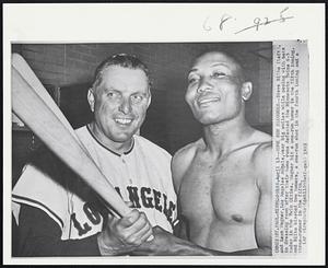 Home Run Sluggers -- Steve Bilko (left) and Leon Wagner, Los Angeles Angels, wear big smiles while posing with bats in dressing room after their home runs defeated the Minnesota Twins 6-3 today in the Twin Cities. Wagner hit a one-run homer in the fifth inning, and Bilko blasted two homers, a one-run shot in the fourth inning and a three-runner in the fifth.