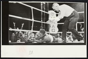 Up and down - Tom Bethea's out in eight round and crowd is on its feet cheering Nino Benvenuti, who won middleweight championship at Umag, Yugoslavia.