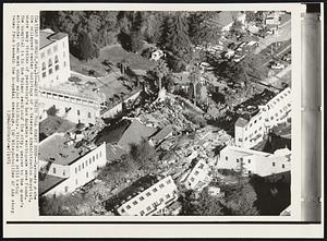 Quake Death Toll Heavy Here -- Rescuers probe the collapsed center building of a Veterans Administration Hospital, where many victims of yesterday's Los Angeles earthquake were found. The hospital is in the Sylmar section of the city, nearer to the quake's epicenter than most other major buildings. Victims are still being taken from beneath the hospital wreckage.