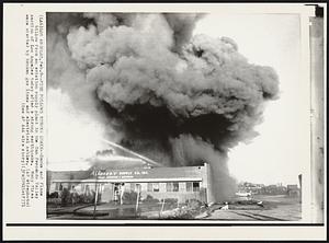 Fire Follows Strong Quake -- Smoke and flame billow from an aviation supply plant in the San Fernando Valley section of Los Angeles today after a strong earthquake. Many fires were started by broken gas lines and electrical cables.