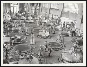 Magnesium for America's Was Effort. This is a scene at the Permanente magnesium plant, one of the country's important defense plants. Here the silver-white metallic chemical element so prized for airplane construction, is being turned out. Magnesium oxide, produced by the heating of magnesite in kilns, is mixed with carbon (petroleum cocke) and heated in vats (see photograph) to 4,000 degrees centrigrade, then suddenly chilled in 1/1000 of a second to 380 degrees precipitating the fine powdered magnesium metal. Magnesium besides being most valuable in airplane manufacture is used in the making of explosives, is used in signaling, pyrotechny and photography. By midsummer Permanente is expected to be one of the country's biggest magnesium plants, with six units going. Three explosions have occurred at the plant and men have died. Magnesium is dangerous stuff to handle: in dust form it blows up at contact with air.