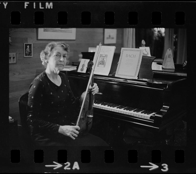 Florence Chapman Pearson seated with violin near piano