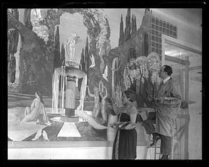 Two people painting an unidentified mural