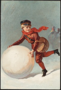 Boy creating a giant snow ball.