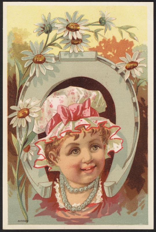Girl with head through a horseshoe, flowers in forefront.