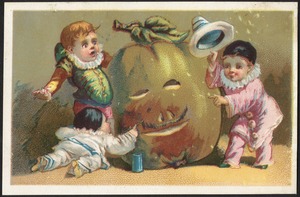 Three boys, one being surprised by a face carved on a squash.