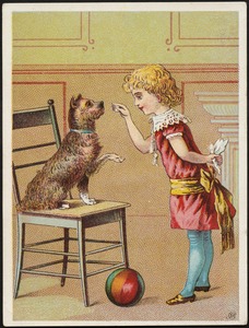 A girl playing with a dog on a chair who is lifting its paw, with a ball in the foreground.