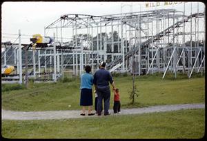 Man, woman & child looking at coaster